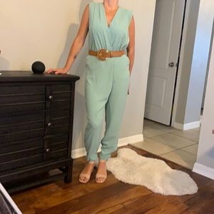 Sage green jumper with a brown moon shaped belt